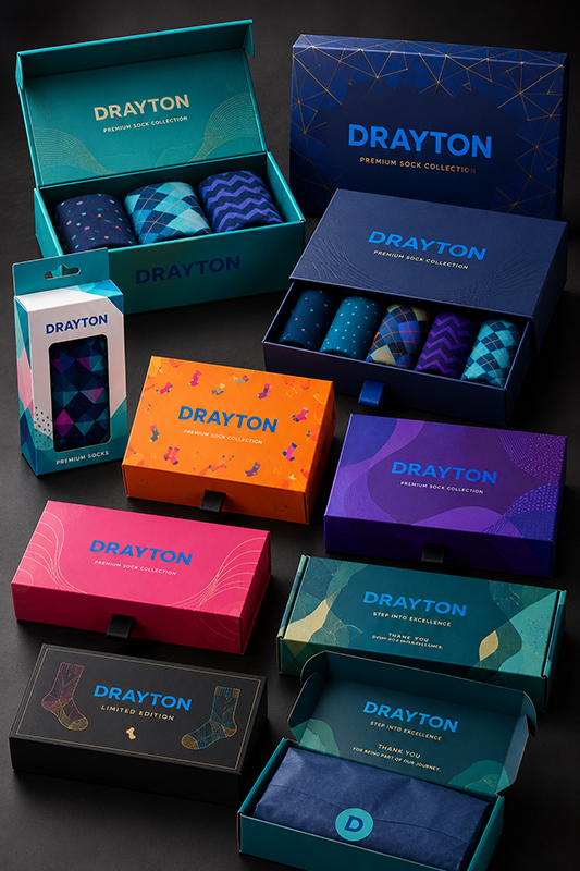 Collection of Drayton sock boxes in various colors on a dark background