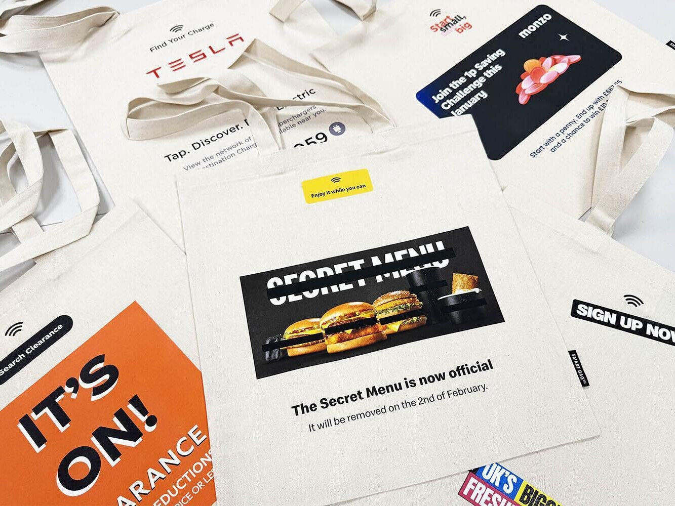 Selection of branded corporate tote bags featuring custom printed promotional designs.