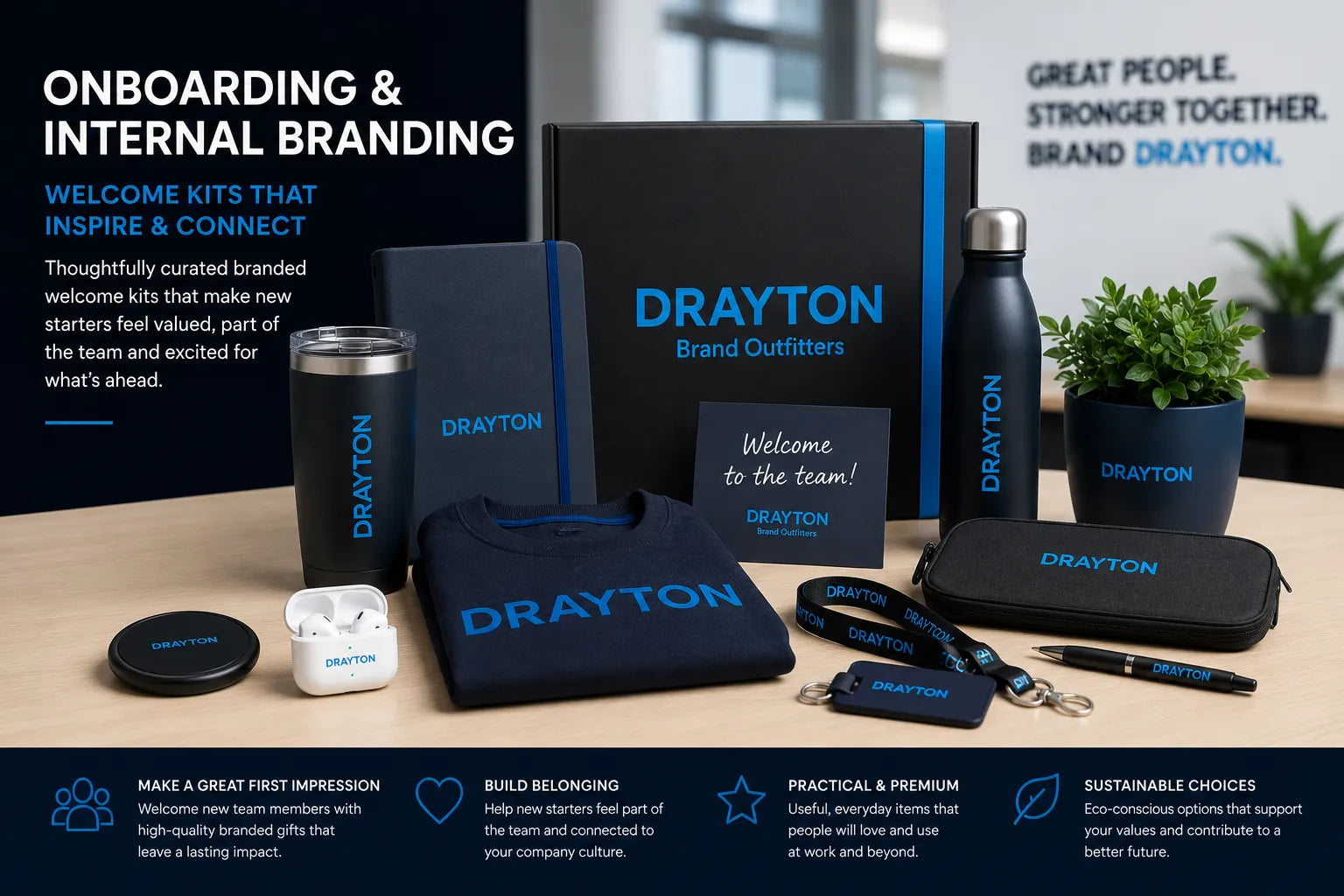 A branded Drayton onboarding and internal branding gift set arranged on a tabletop, including a black tumbler, insulated bottle, tote bag, pouch, earbud case, keychain, pen, and small plants, with matching black and blue packaging and printed Drayton branding.