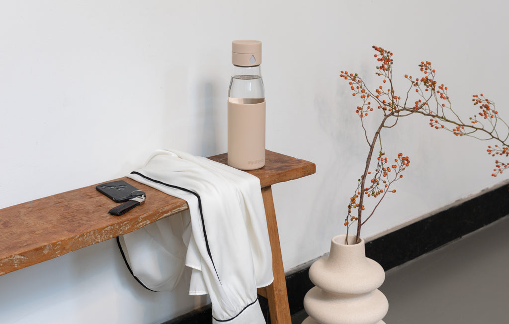 Ukiyo glass hydration tracking bottle with sleeve